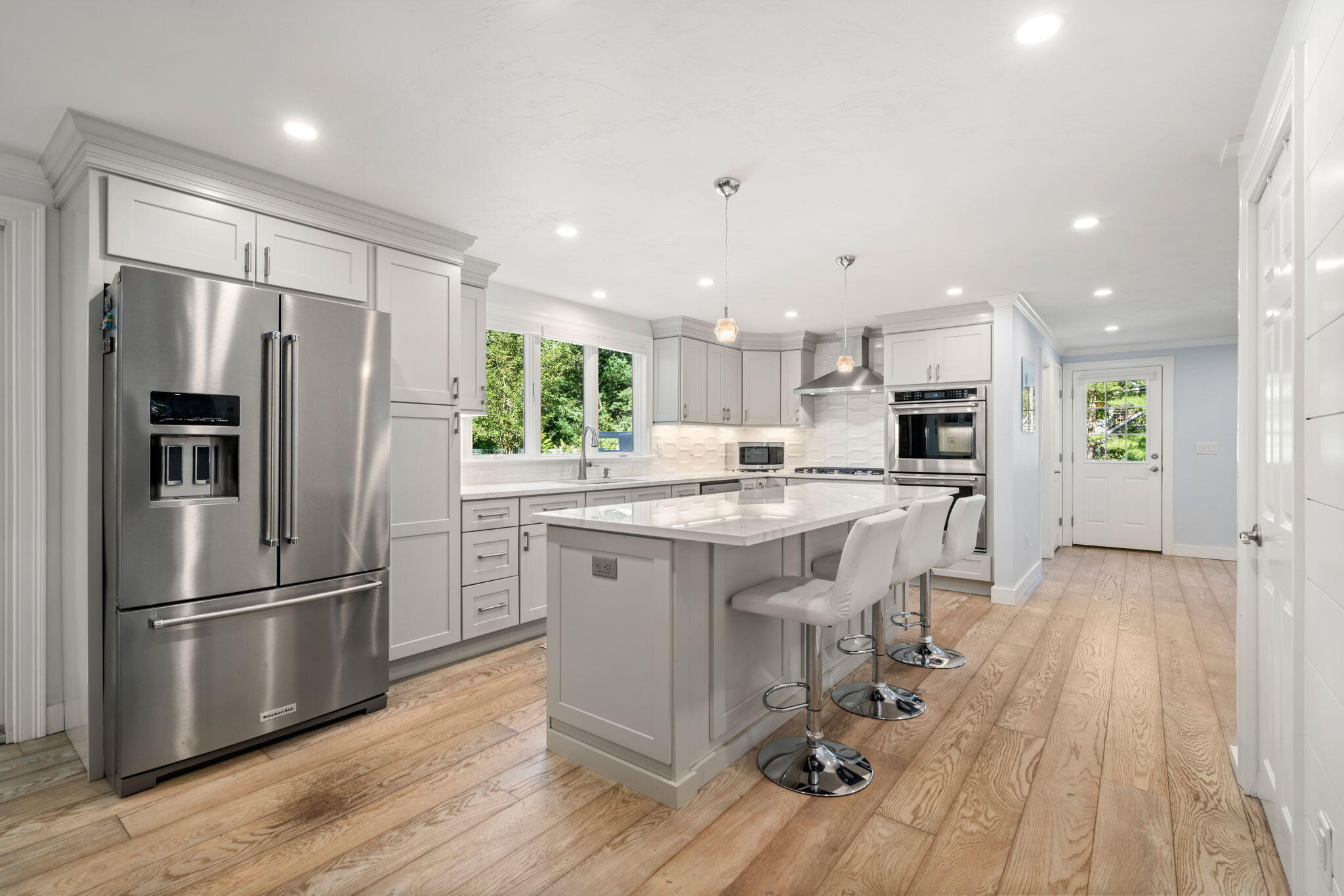 41 Old Fields Road Sandwich, MA 02563 - Photo 7 of 47 a kitchen with kitchen island white cabinets and stainless steel appliances