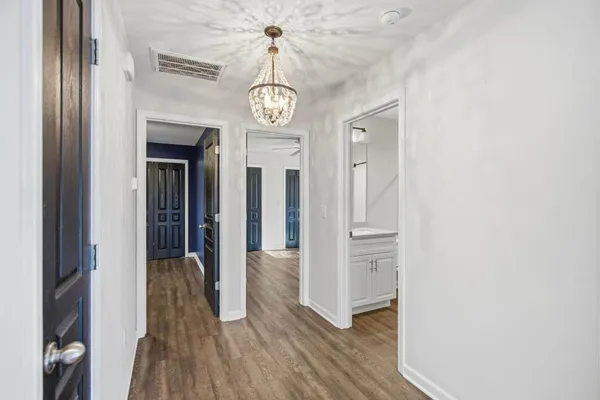 an empty room with wooden floor and a window