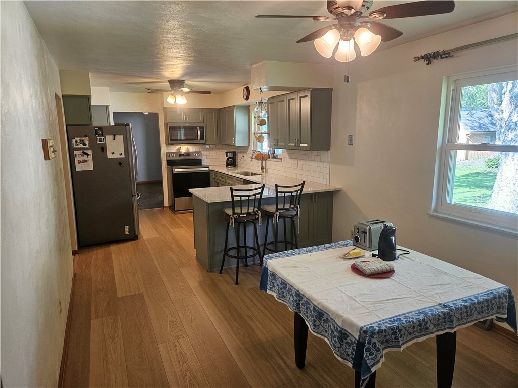 3998 Willowcrest Road Beavercreek, OH 45430 - Photo 11 of 41 This kitchen features a bright dining space and modern appliances, perfect for everyday living.