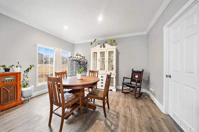 a view of a dining room with furniture window and wooden floor
