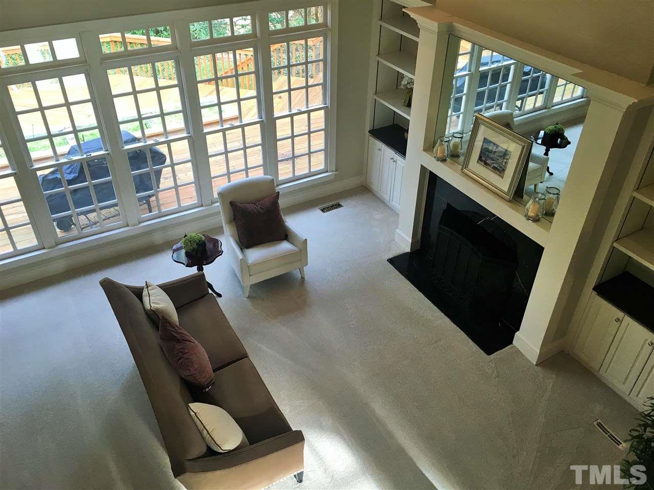 1917 Torrey Pines Place Raleigh, NC 27615 - Photo 8 of 25 a living room with furniture and a fireplace