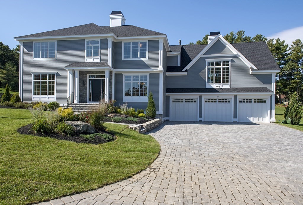 a front view of a house with a yard and porch