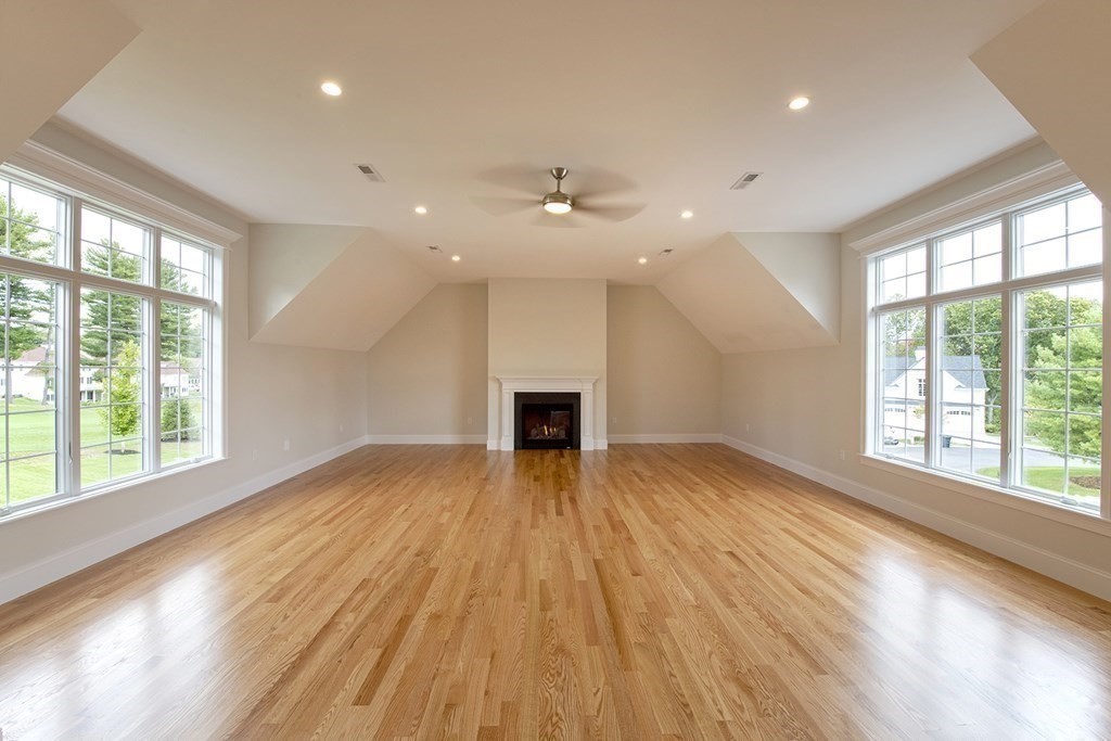 10 Trevino Circle Andover, MA 01810 - Photo 18 of 33 a view of empty room with wooden floor and fireplace