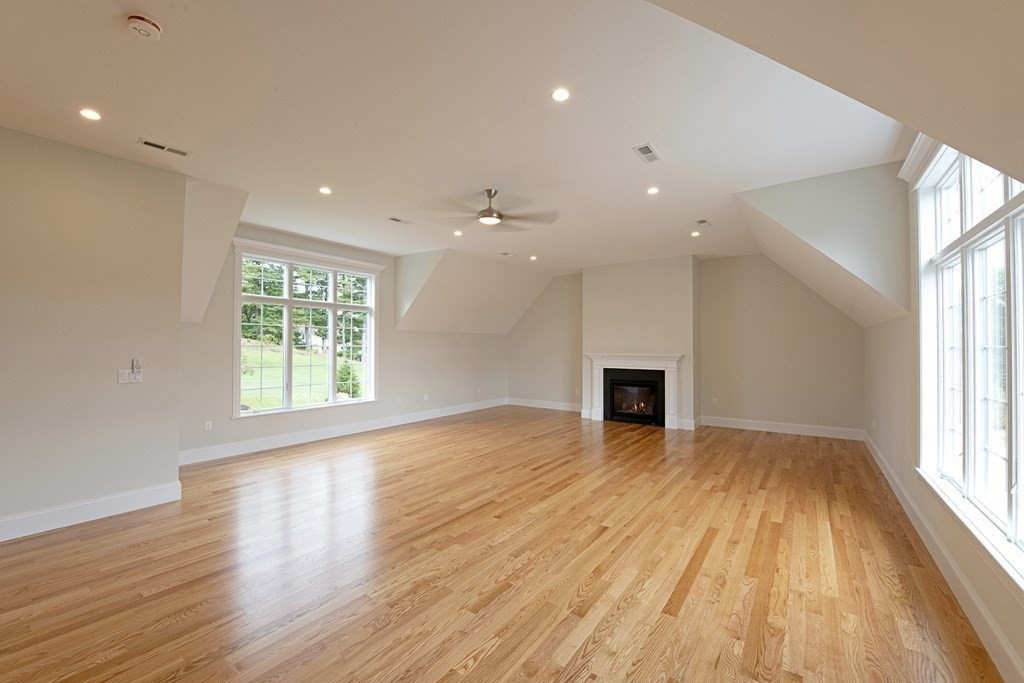 10 Trevino Circle Andover, MA 01810 - Photo 19 of 33 a view of a livingroom with wooden floor and a fireplace
