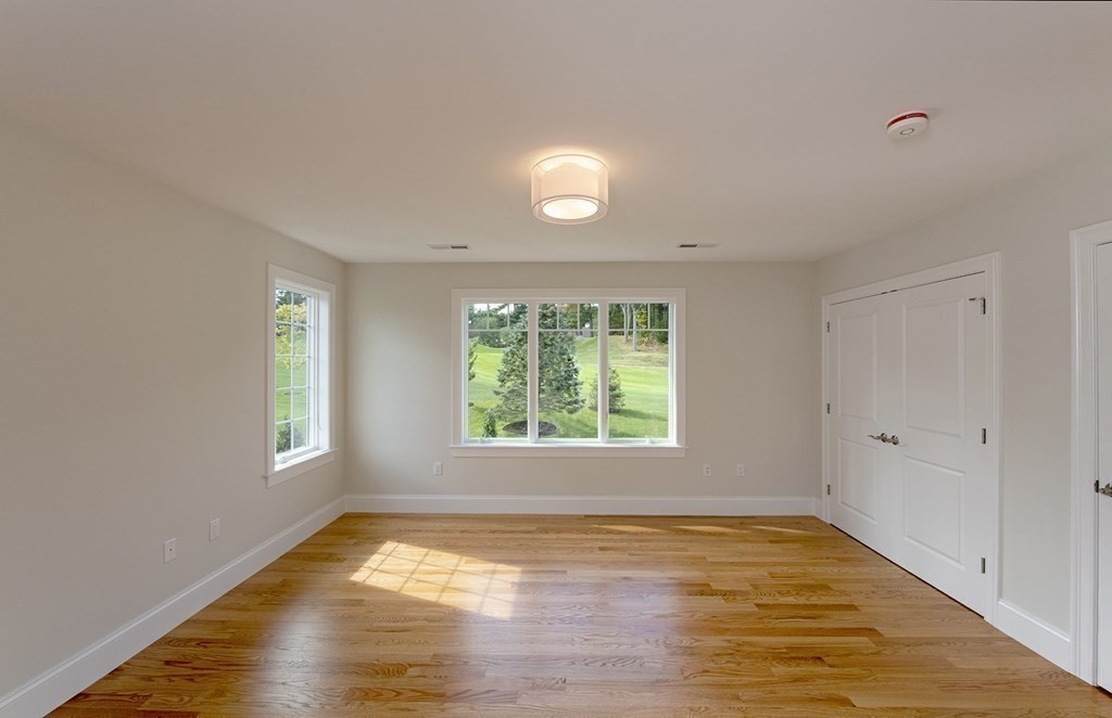 10 Trevino Circle Andover, MA 01810 - Photo 21 of 33 a view of empty room with wooden floor and fan