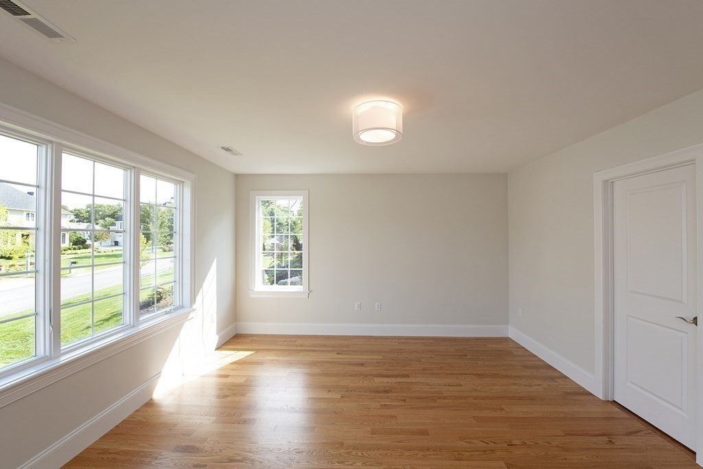 10 Trevino Circle Andover, MA 01810 - Photo 22 of 33 a view of an empty room with wooden floor and a window