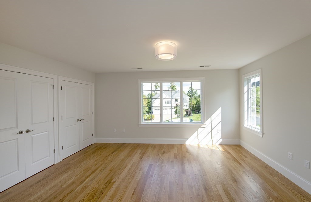 10 Trevino Circle Andover, MA 01810 - Photo 23 of 33 an empty room with wooden floor and windows