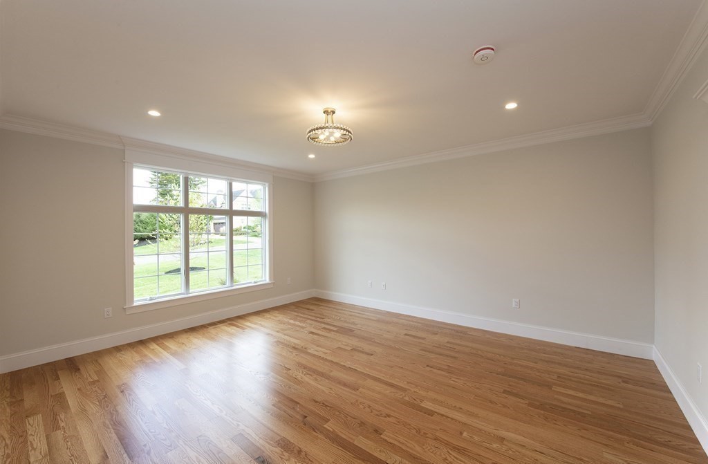 10 Trevino Circle Andover, MA 01810 - Photo 24 of 33 a view of an empty room with wooden floor and a window