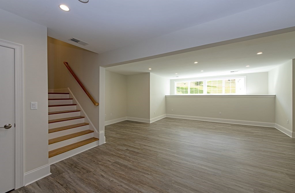 10 Trevino Circle Andover, MA 01810 - Photo 29 of 33 a view of an empty room with wooden floor and stairs