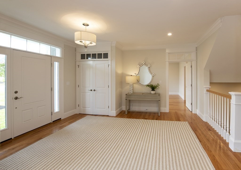 10 Trevino Circle Andover, MA 01810 - Photo 4 of 33 a bedroom with a bed and a chandelier