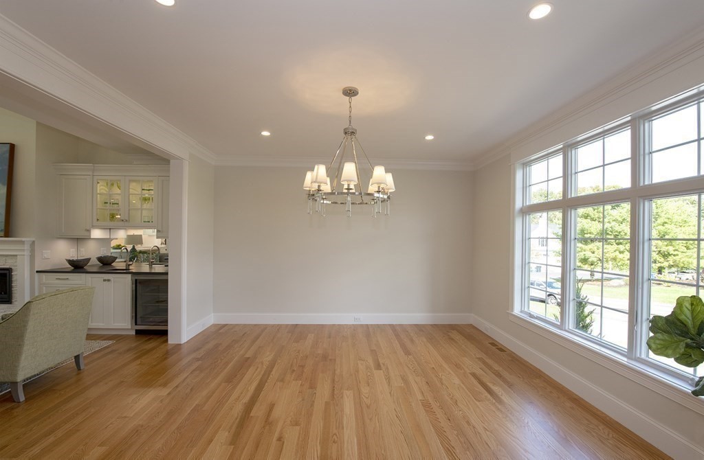 10 Trevino Circle Andover, MA 01810 - Photo 9 of 33 a view of a room with wooden floor stove and kitchen view