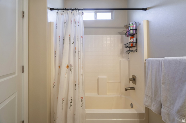 700 North Main Street, Unit F3 Washington, UT 84780 - Photo 21 of 34 Bathtub and shower combination featuring neutral tile surround and brushed nickel fixtures