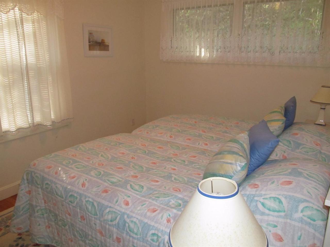 248 Pimlico Pond Road Mashpee, MA 02649 - Photo 15 of 22 a bedroom with a bed and a chandelier