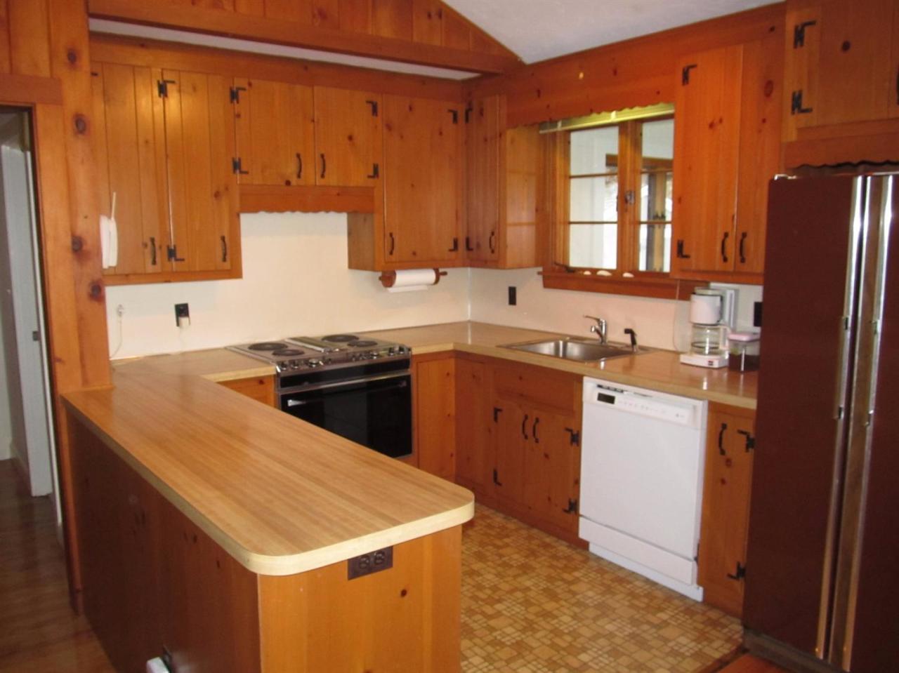 248 Pimlico Pond Road Mashpee, MA 02649 - Photo 18 of 22 a kitchen that has a sink a stove and a refrigerator