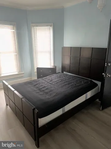 a bed sitting in a bedroom next to a window