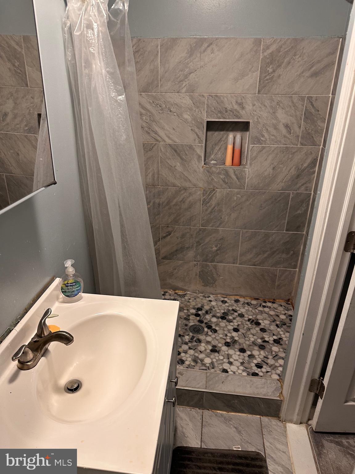 321 South Augusta Avenue Baltimore, MD 21229 - Photo 4 of 7 a bathroom with a sink and a shower