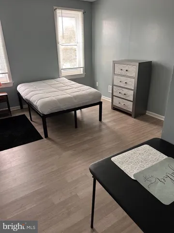 a room with a table chairs and wooden floor