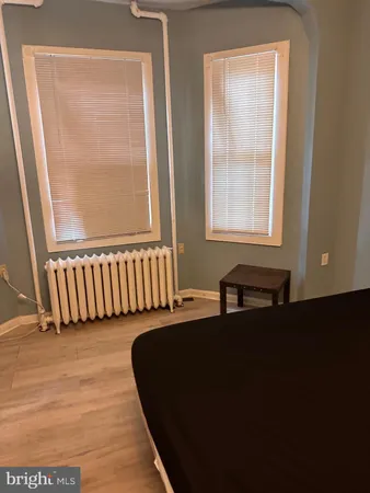 a front view of a house with a black gate