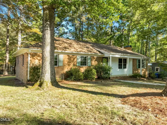 a view of a house with a tree