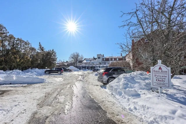 a view of a house with snow next to a road