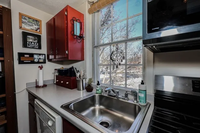 a kitchen with a sink and a stove top oven