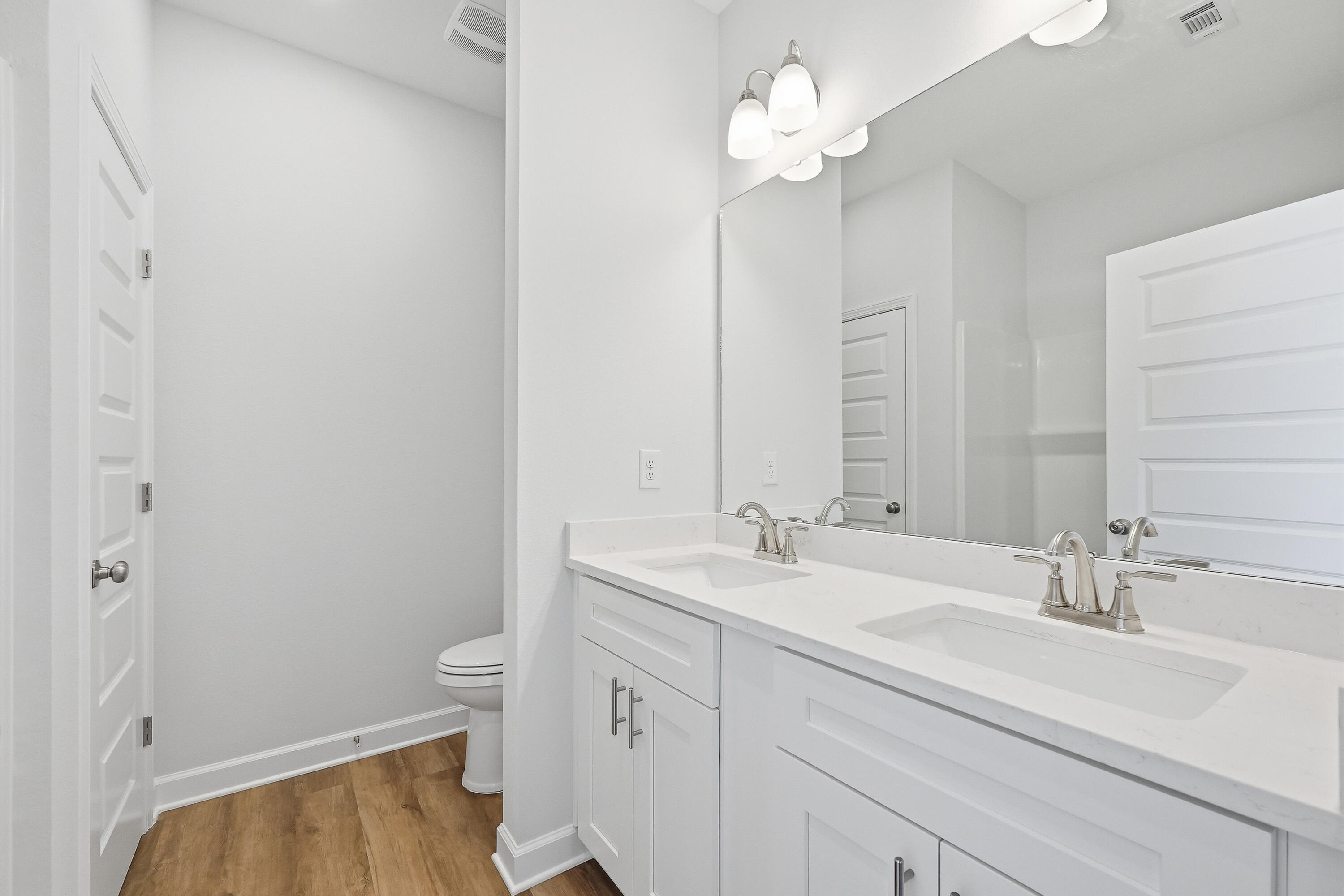 6138 Clover Street Crestview, FL 32539 - Photo 13 of 21 a bathroom with a sink a toilet and a mirror