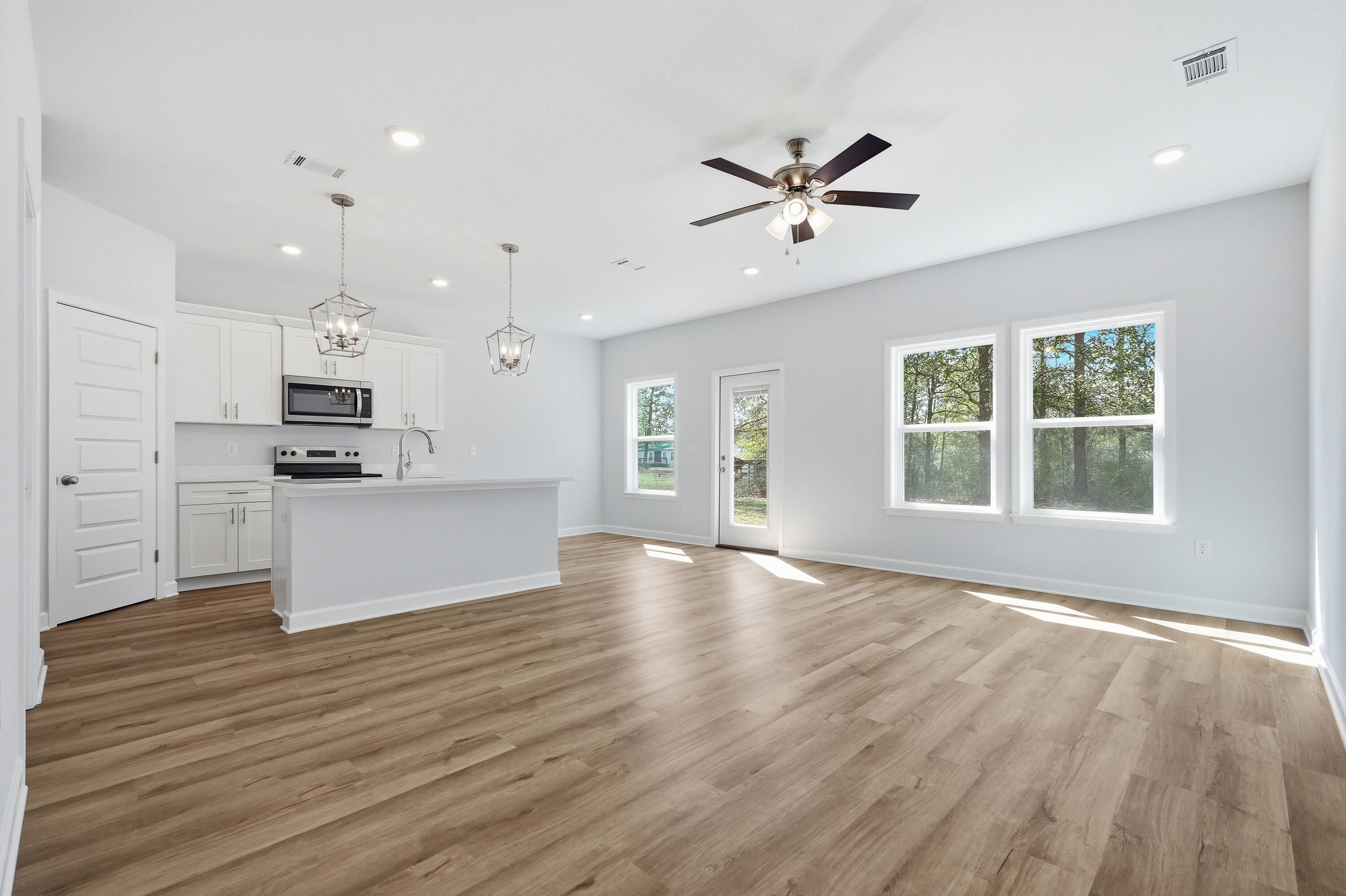 6138 Clover Street Crestview, FL 32539 - Photo 3 of 21 a view of an empty room with kitchen appliances and a window