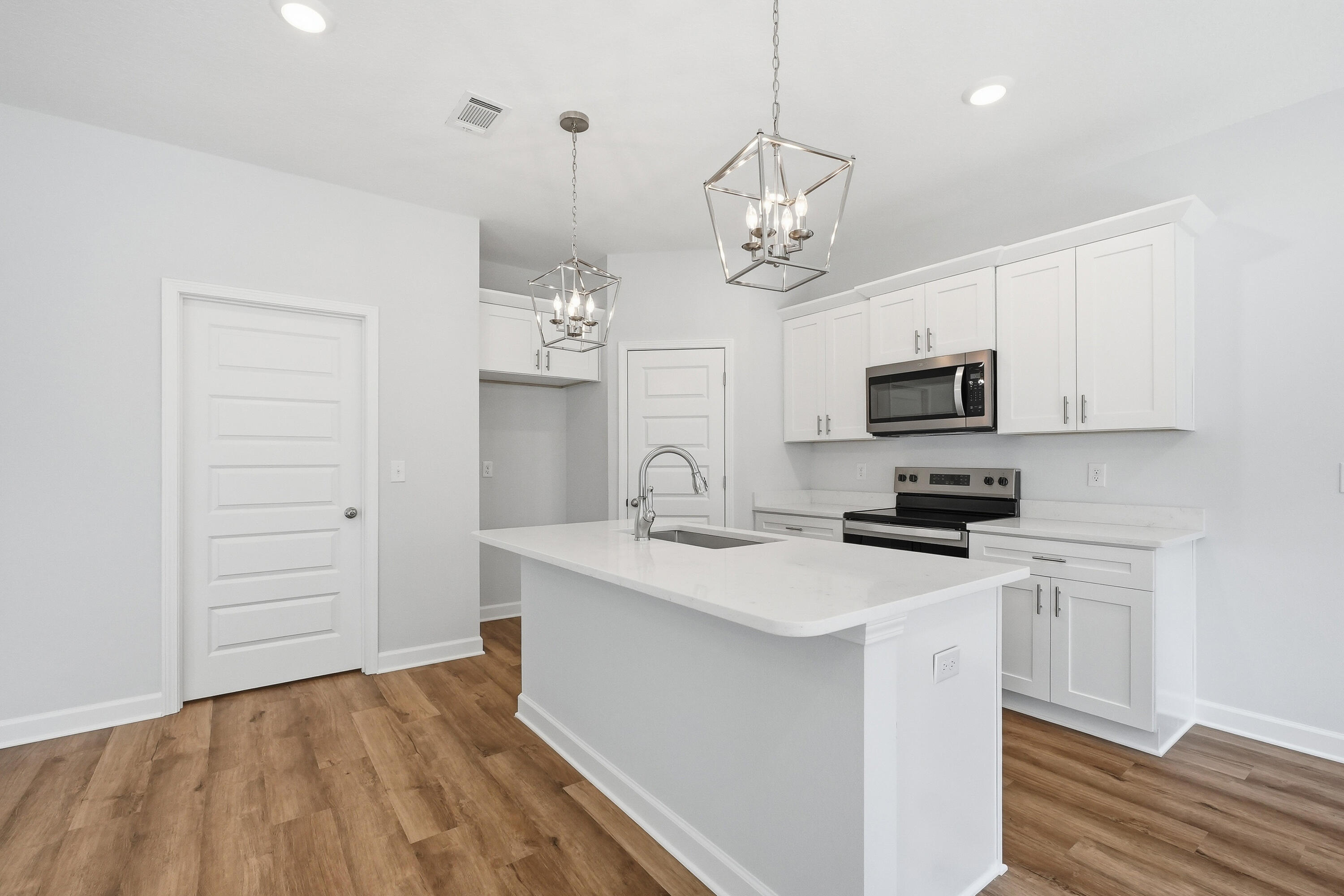 6138 Clover Street Crestview, FL 32539 - Photo 8 of 21 a kitchen with stainless steel appliances a stove refrigerator and microwave