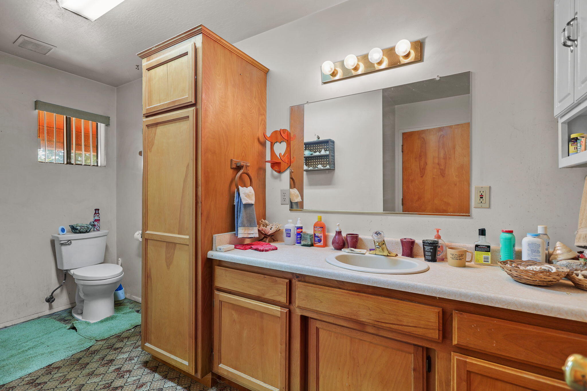 15015 Highway 36, Unit WEST Red Bluff, CA 96080 - Photo 13 of 51 a bathroom with a sink vanity mirror and toilet