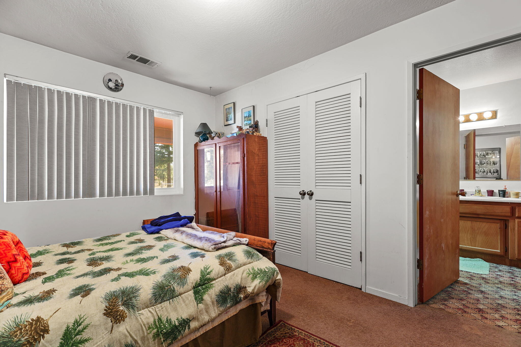 15015 Highway 36, Unit WEST Red Bluff, CA 96080 - Photo 16 of 51 a bed sitting in a bedroom next to a bathroom