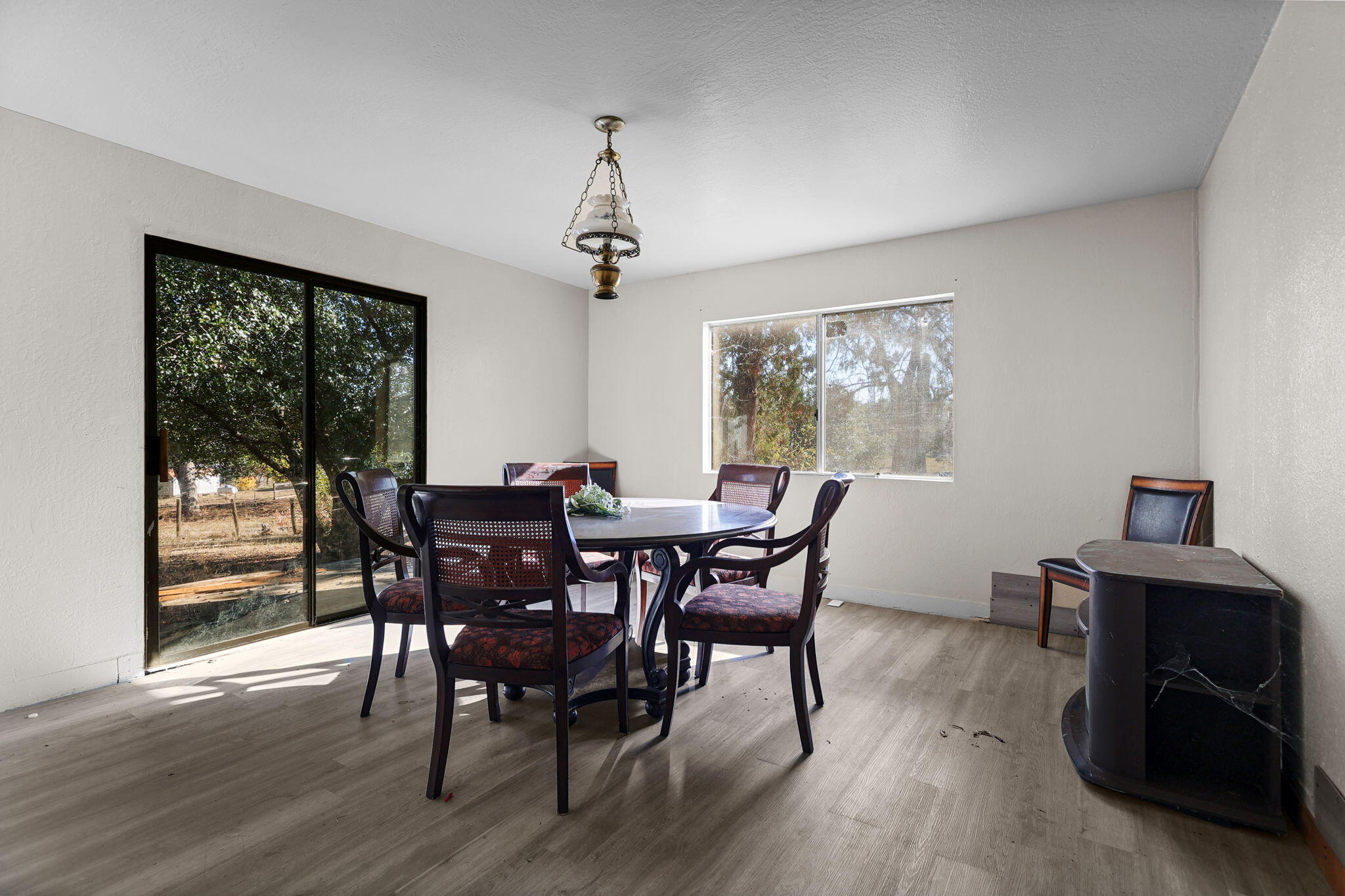15015 Highway 36, Unit WEST Red Bluff, CA 96080 - Photo 26 of 51 a view of a dining room with furniture window and wooden floor