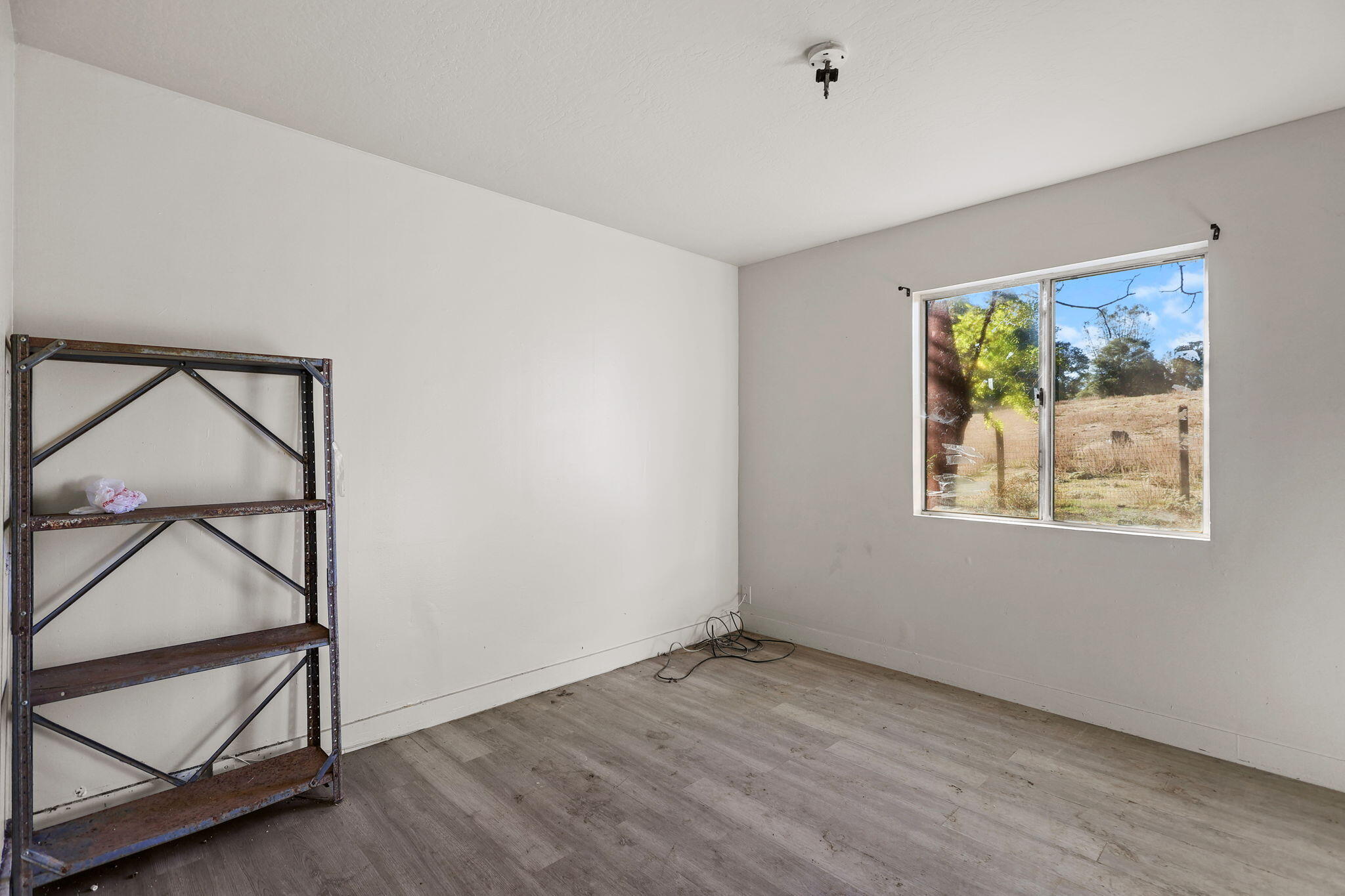 15015 Highway 36, Unit WEST Red Bluff, CA 96080 - Photo 30 of 51 a view of room with window and wooden floor