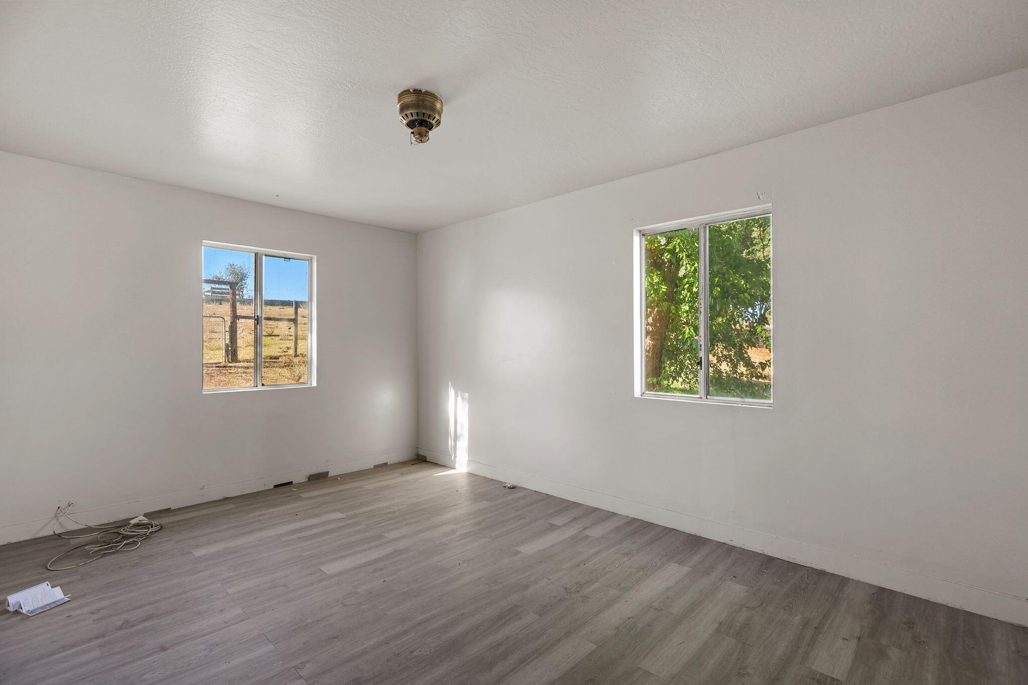 15015 Highway 36, Unit WEST Red Bluff, CA 96080 - Photo 32 of 51 an empty room with wooden floor and windows