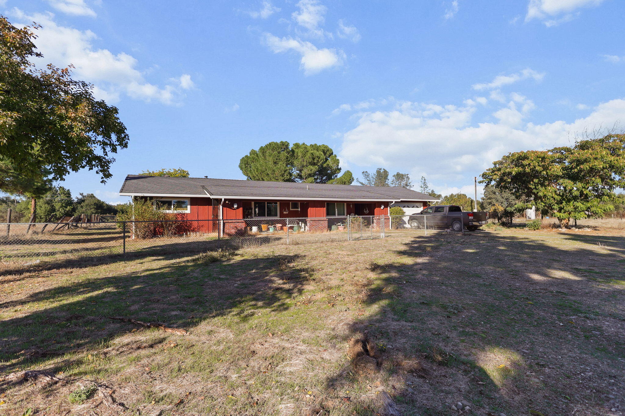 15015 Highway 36, Unit WEST Red Bluff, CA 96080 - Photo 42 of 51 a view of a big house with a big yard and large trees