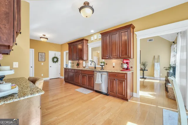 a large kitchen with kitchen island a sink stainless steel appliances and cabinets