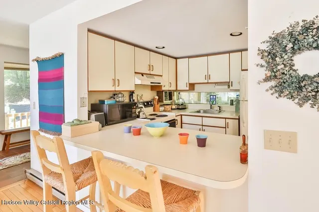 a kitchen with stainless steel appliances a stove a table and chairs