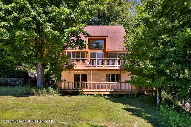 a aerial view of a house with swimming pool next to a yard