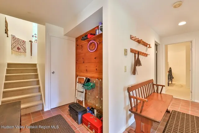 a view of a hallway and a livingroom with furniture
