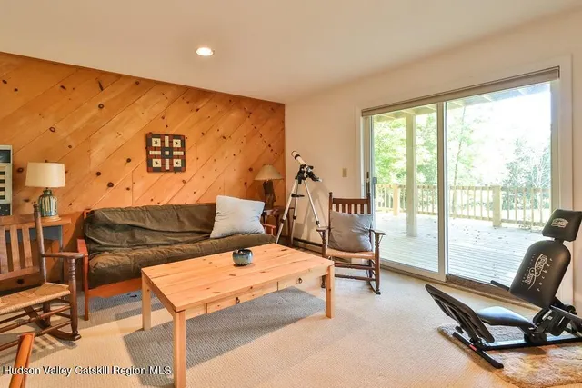 a bedroom with a bed and glass door