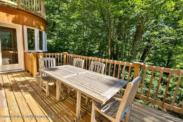 a view of balcony with wooden floor and seating space