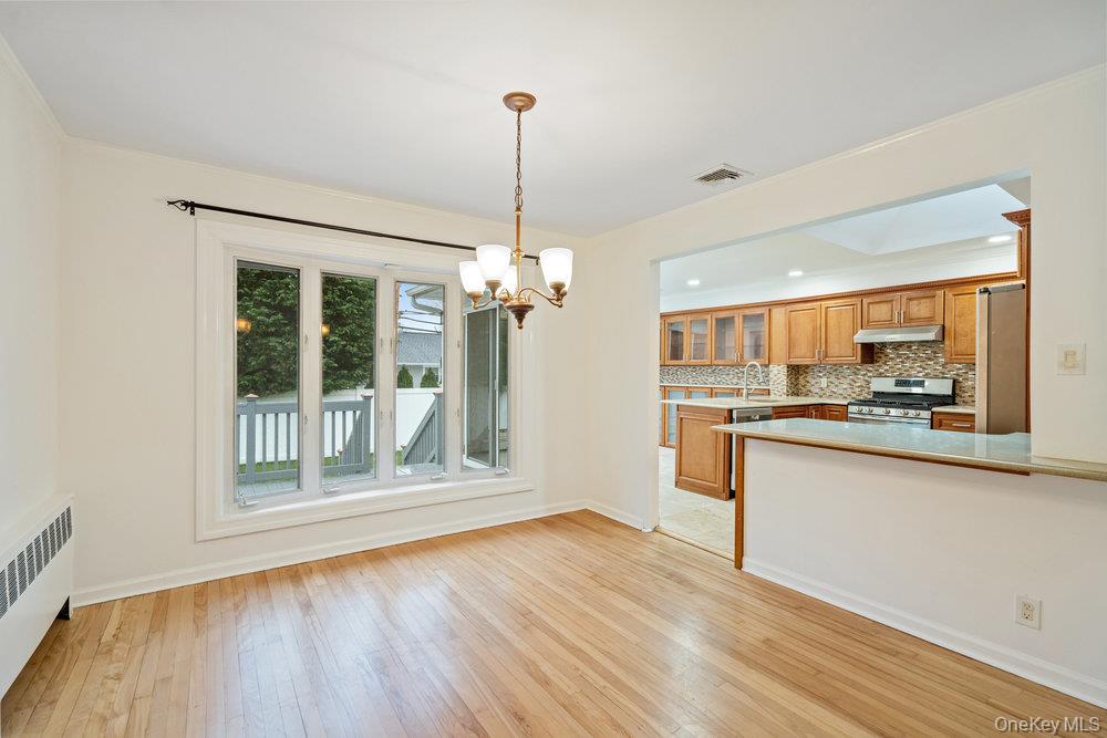 15 Morris Drive Syosset, NY 11791 - Photo 12 of 32 a view of a kitchen with wooden floor and a window
