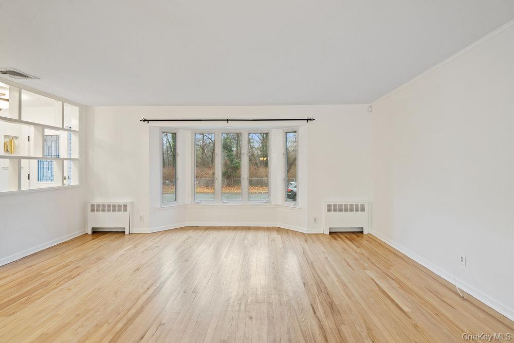 15 Morris Drive Syosset, NY 11791 - Photo 15 of 32 wooden floor in an empty room with a window