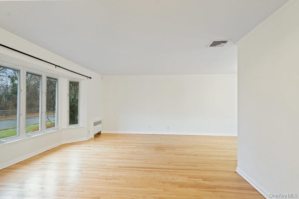 15 Morris Drive Syosset, NY 11791 - Photo 16 of 32 a view of an empty room with wooden floor and a window