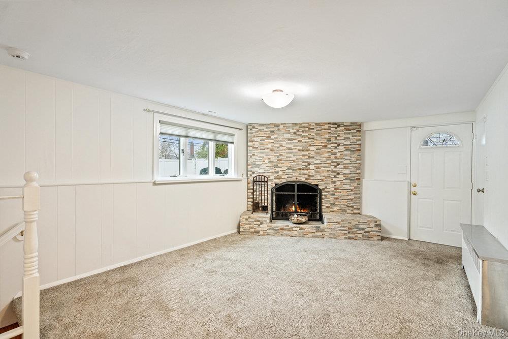 15 Morris Drive Syosset, NY 11791 - Photo 17 of 32 an empty room with a fireplace and window