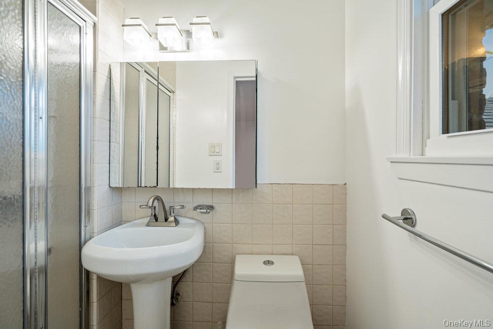 15 Morris Drive Syosset, NY 11791 - Photo 22 of 32 a bathroom with a sink and a mirror