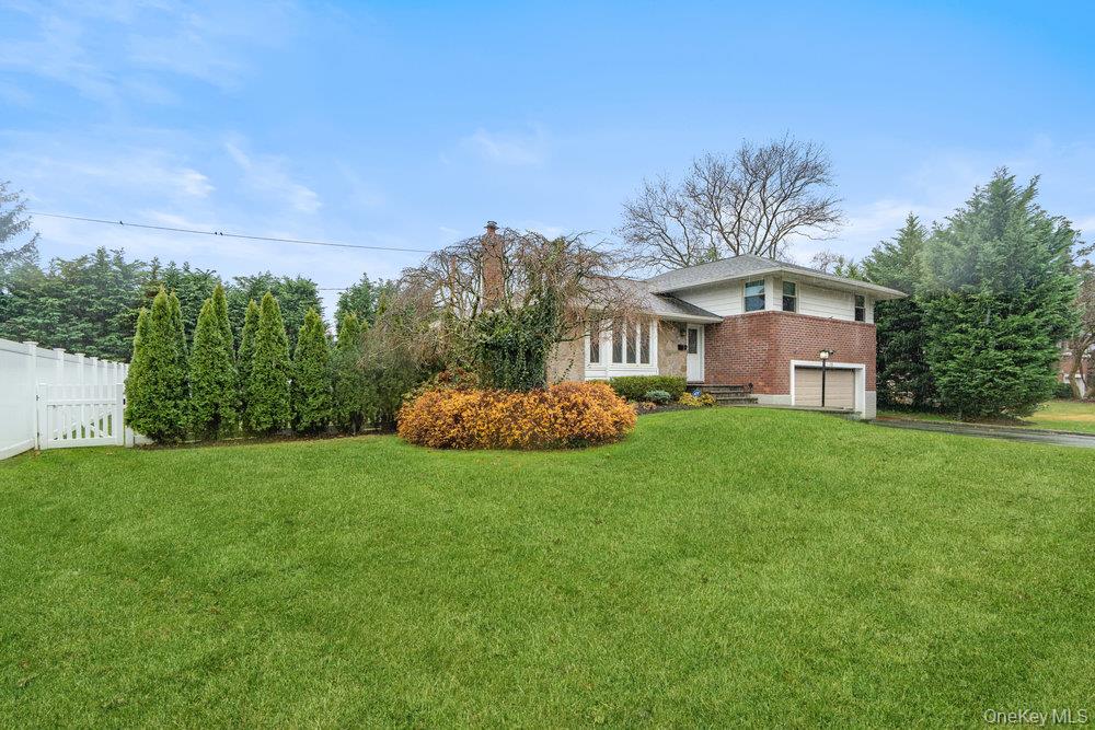 15 Morris Drive Syosset, NY 11791 - Photo 30 of 32 a front view of a house with a yard and trees