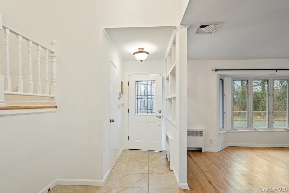 15 Morris Drive Syosset, NY 11791 - Photo 3 of 32 a view of a hallway with wooden floor and a bathroom