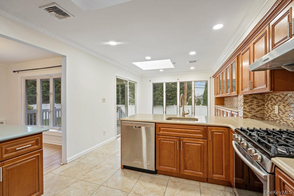 15 Morris Drive Syosset, NY 11791 - Photo 5 of 32 a kitchen with stainless steel appliances granite countertop a stove and a sink