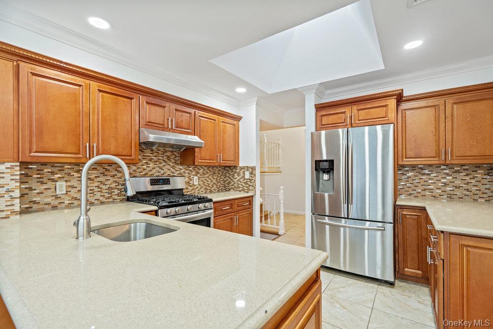 15 Morris Drive Syosset, NY 11791 - Photo 6 of 32 a kitchen with stainless steel appliances granite countertop a refrigerator stove and sink