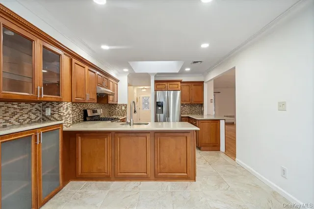 a kitchen with stainless steel appliances granite countertop a sink and cabinets